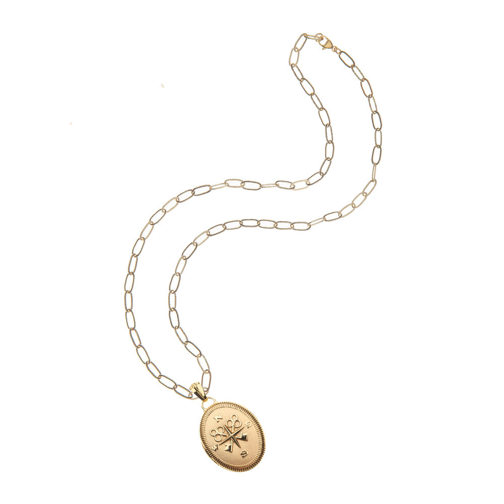 Flat lay of Forever JW Original Locket necklace showcasing oval gold locket with compass motif on drawn-link chain on white background