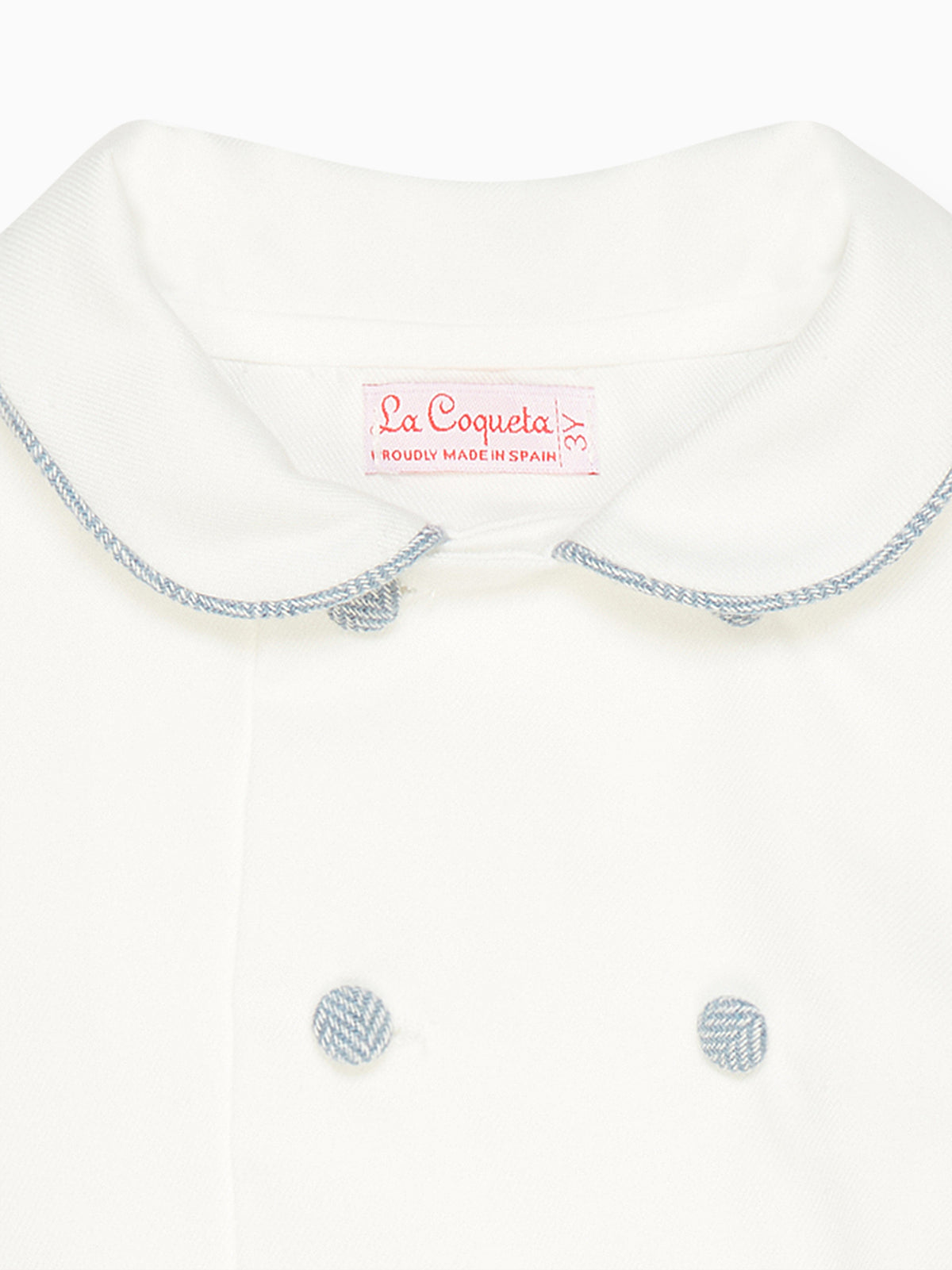 Close-up front of Friso baby boy set top showing Peter Pan collar with blue piped trim and two covered buttons