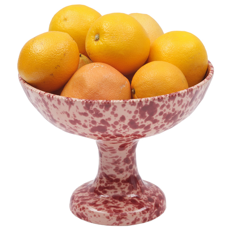 Front view of Speckled Fruit Stand in Pink showing its hand-painted finish and scalloped rim with oranges on white