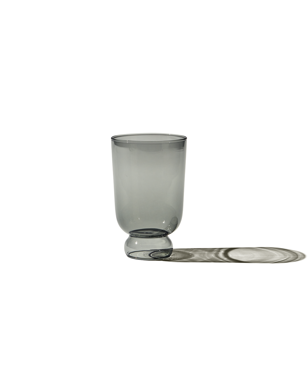 Front view of Full Glass (haze) showing round pedestal base and thin borosilicate walls on dark background