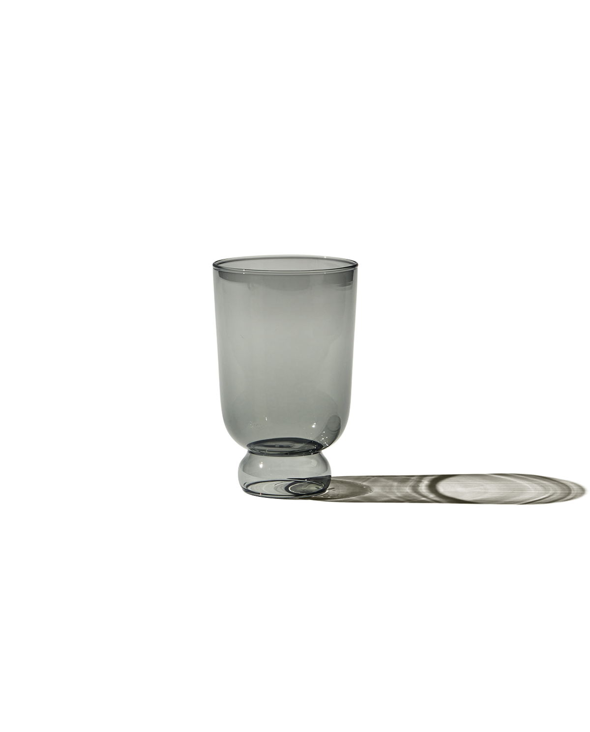 Front view of Full Glass (haze) showing round pedestal base and thin borosilicate walls on dark background