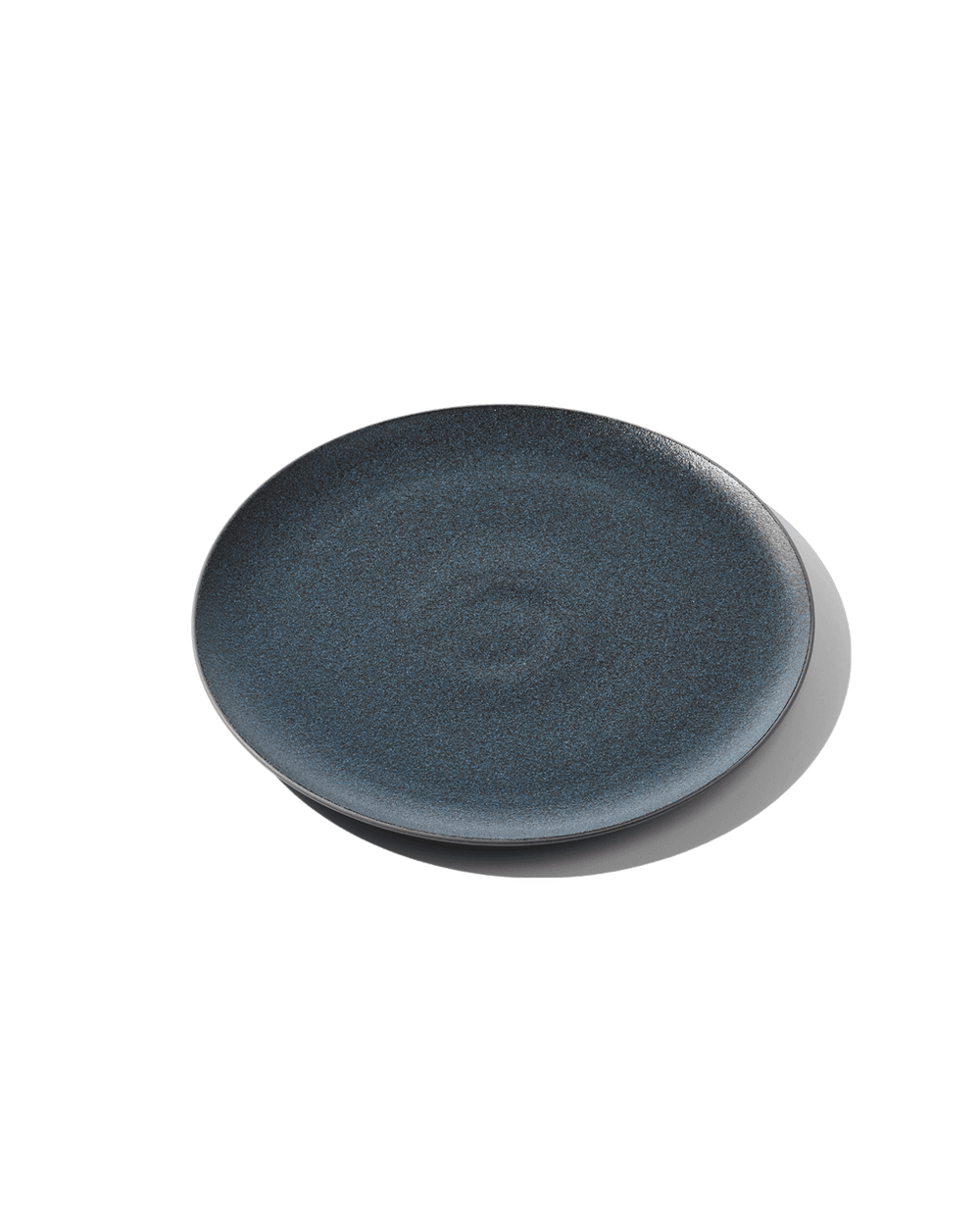 Angled top-down view of The Full Plate showing speckled Grotto-blue glaze and low rim on a white background