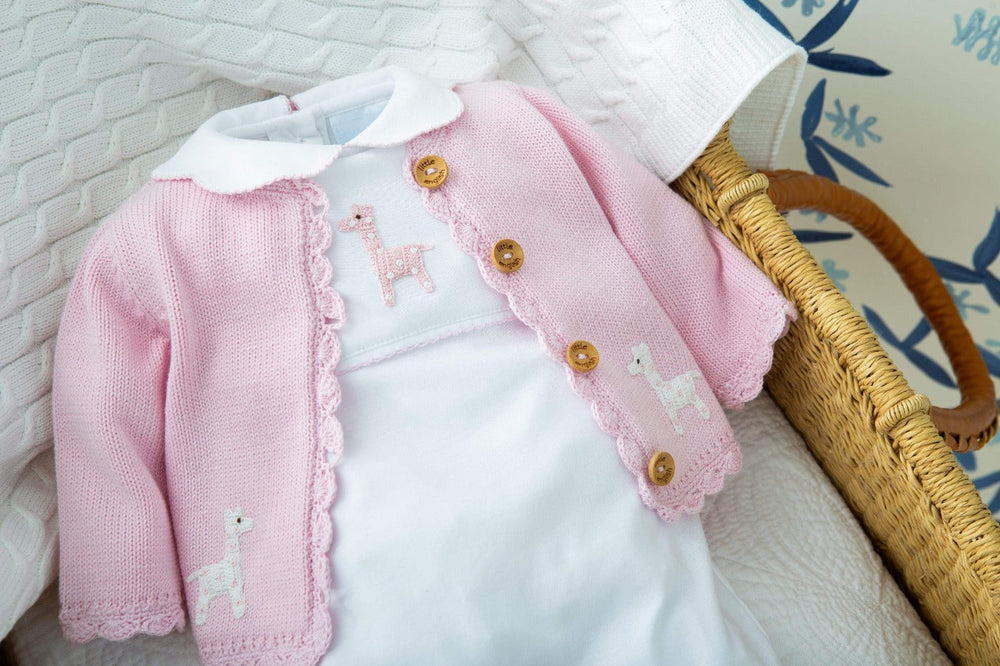 Close-up of Girl Giraffe crochet playsuit with pink cardigan showing embroidered giraffes, Peter Pan collar, picot trim, and wooden buttons