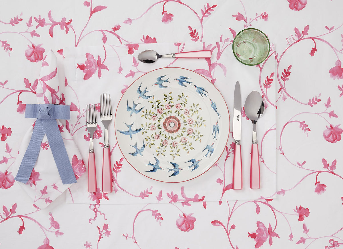 Flat lay of Botanical Tablecloth in Rose Botanical showcasing pink watercolor floral vine pattern with styled place setting