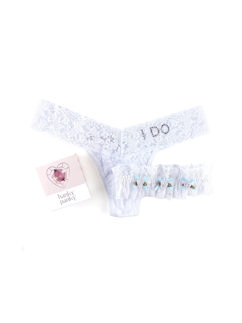 Top view of white lace low-rise thong and matching garter showcasing I DO rhinestone waistband and blue ribbon accents on white background