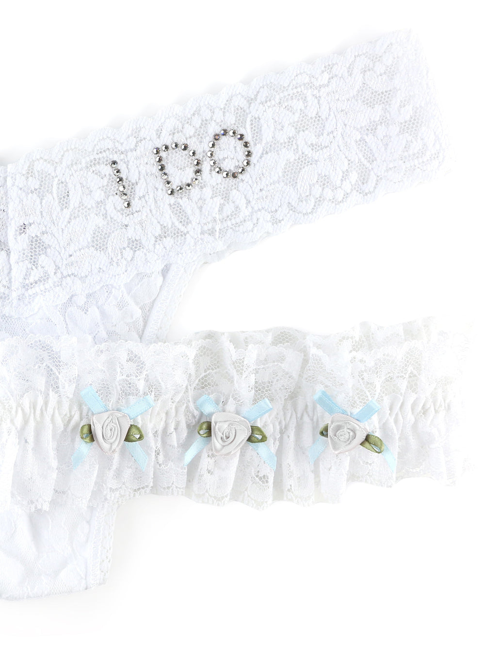 Close-up of I Do low-rise lace thong and garter showcasing rhinestone I DO on waistband and ruffled garter with blue ribbon roses