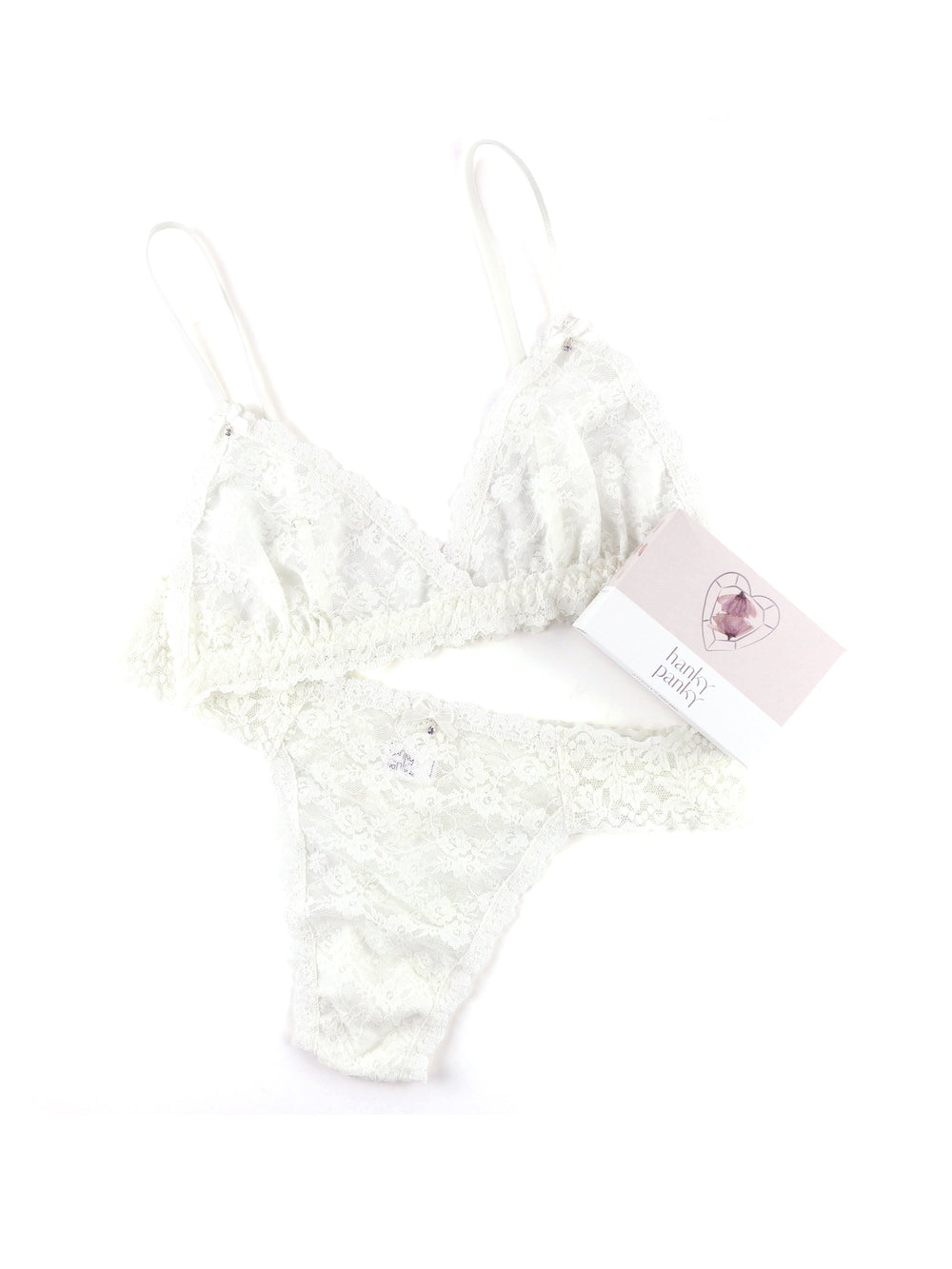 Flat lay of Original Rise Wedding Night Box Set bralette and thong in light ivory showcasing sheer floral lace on white background