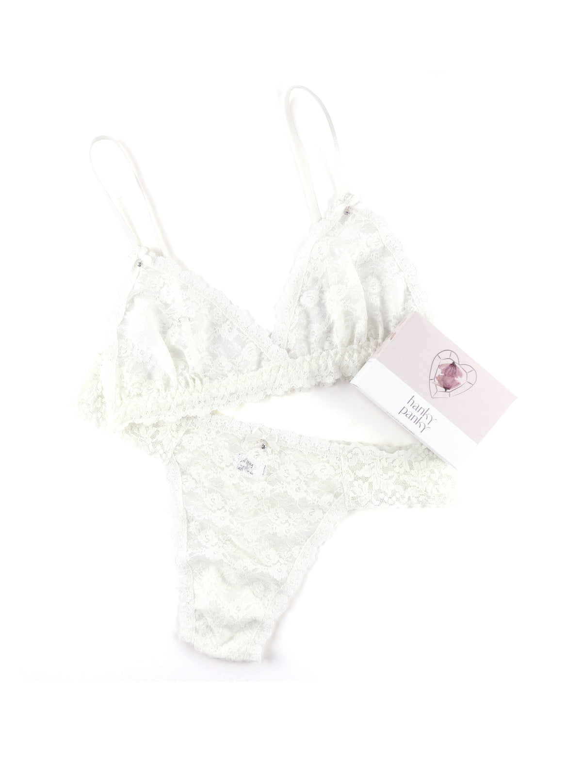 Flat lay of Original Rise Wedding Night Box Set bralette and thong in light ivory showcasing sheer floral lace on white background