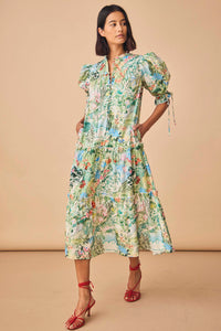 The Holloway dress has a split neck, puff sleeves, a self-tie belt and tiered ruffle seams.