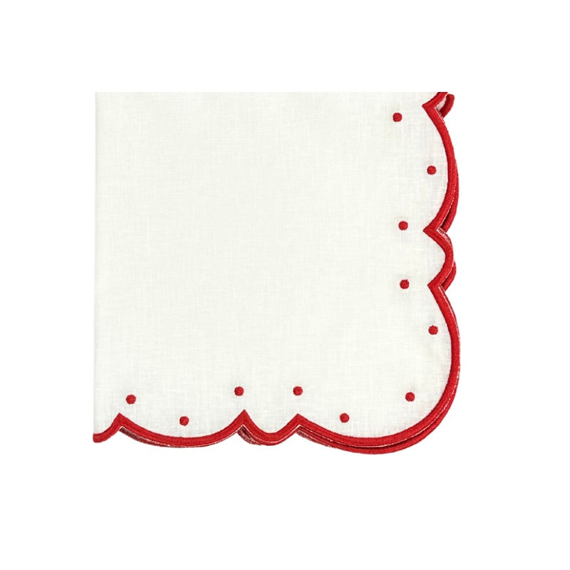 Close-up of Ava napkin showcasing white linen with red scalloped silk embroidery and dots on a white background