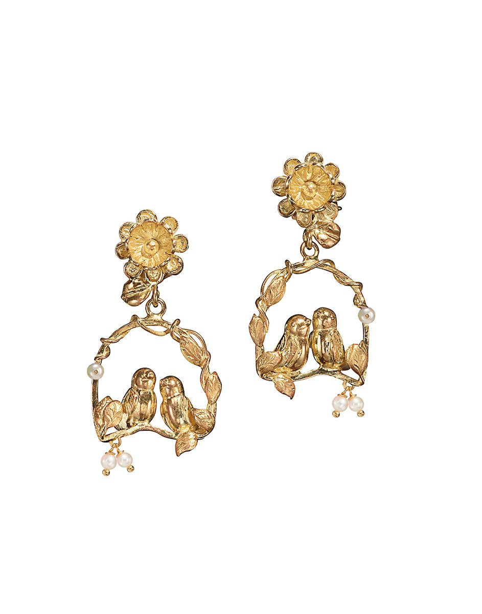 Front view of Inseparables earrings showing two birds on a gold floral hoop with small dangling pearls on white background