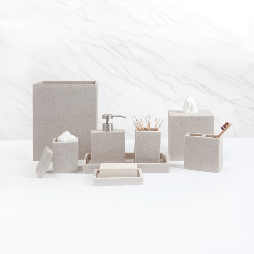 Front view of Slate bath accessory set in Ivory showcasing minimalist resin texture with white marble background