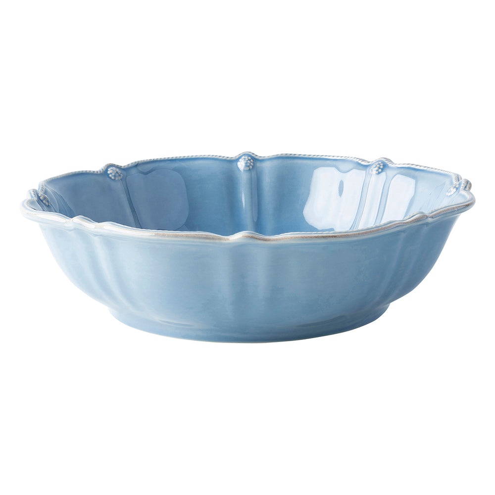 Angled view of Berry and Thread Chambray 13 inch bowl showcasing scalloped beaded rim and blue chambray glaze on white background