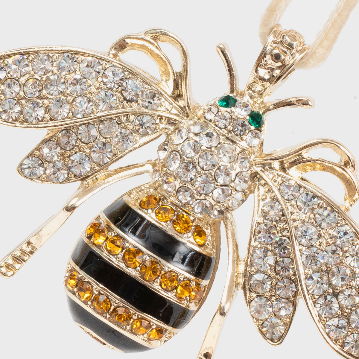 Close-up of Stripey Bee Hanging Ornament showcasing jeweled wings and striped body on a white background