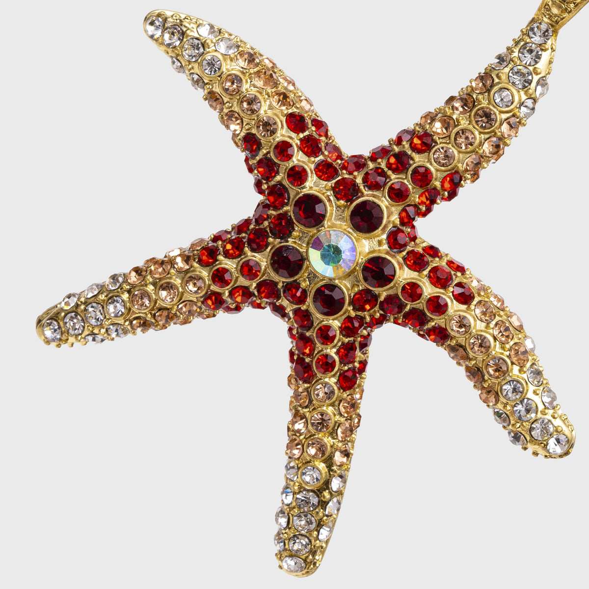 Close-up of Starfish Hanging Ornament in Coral showcasing multicolored glass crystals on a gold-tone zinc starfish against light gray