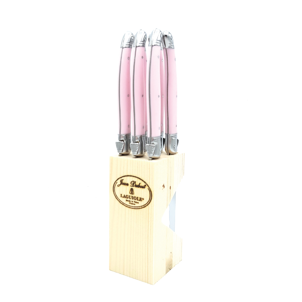 Front view of steak knife set in wooden block showcasing six pink-handled Jean Dubost Laguiole knives on white background