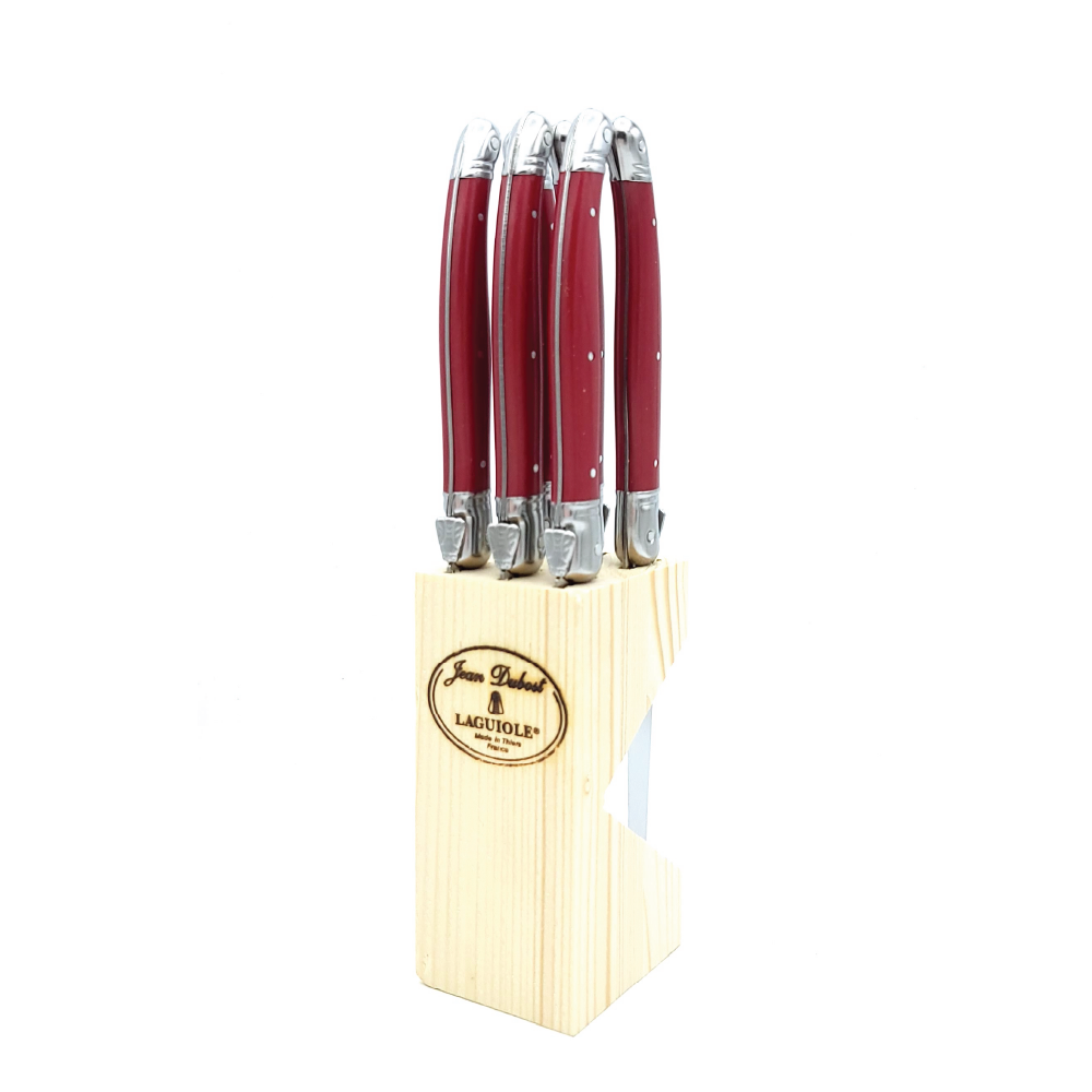 Front view of Jean Dubost Laguiole steak knives set of 6 showcasing red handles in a wooden block on white background