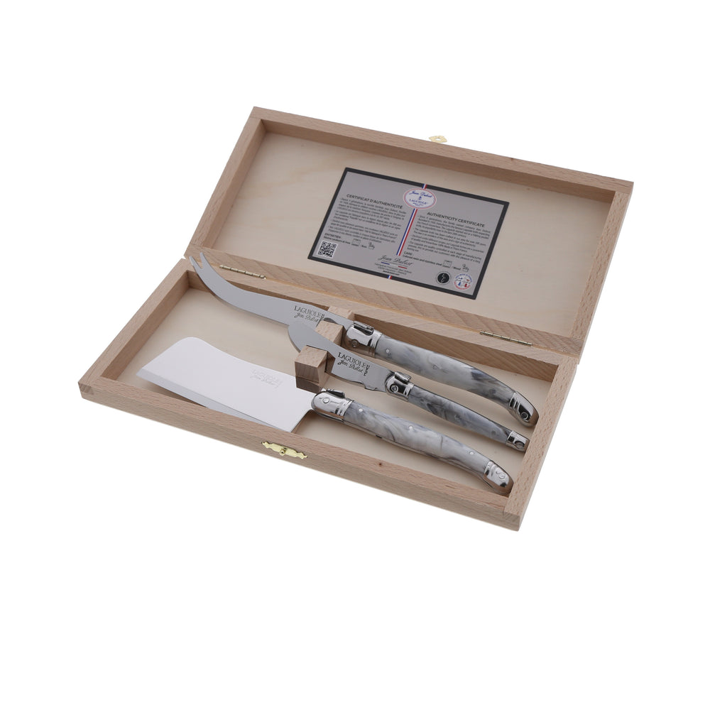 Top view of 3-piece cheese knife set with gray marble acrylic handles and stainless steel blades in a wooden box
