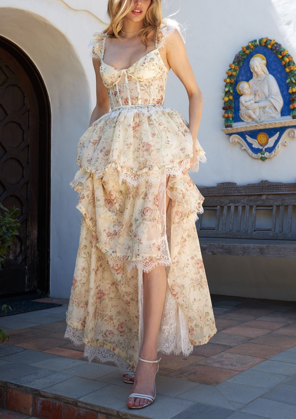 Front view of The Jolie Dress in Carmel Valley Rose showcasing corset bodice and lace layers in an outdoor setting