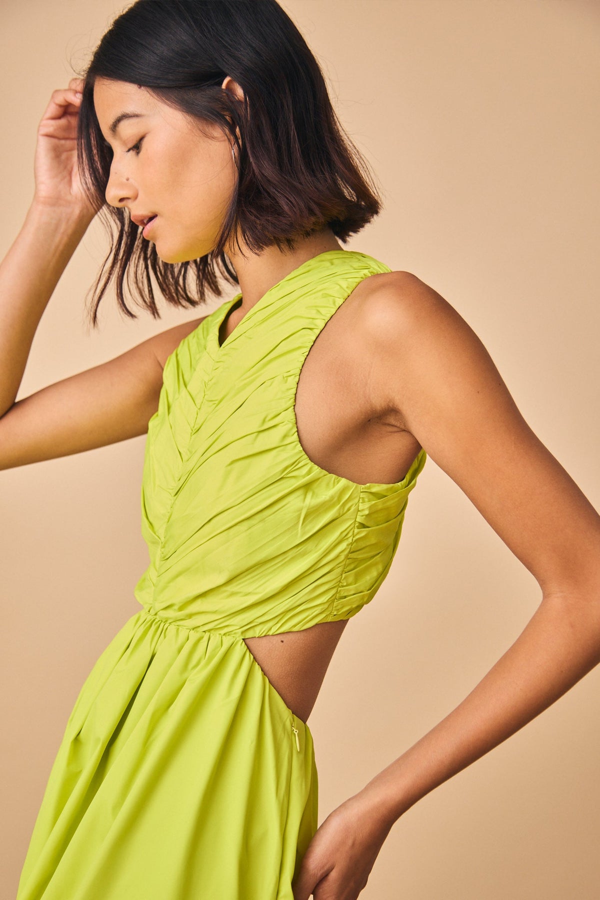 This midi taffeta dress, has a ruched bodice, shirred skirt, and cut-out elastic back waist.