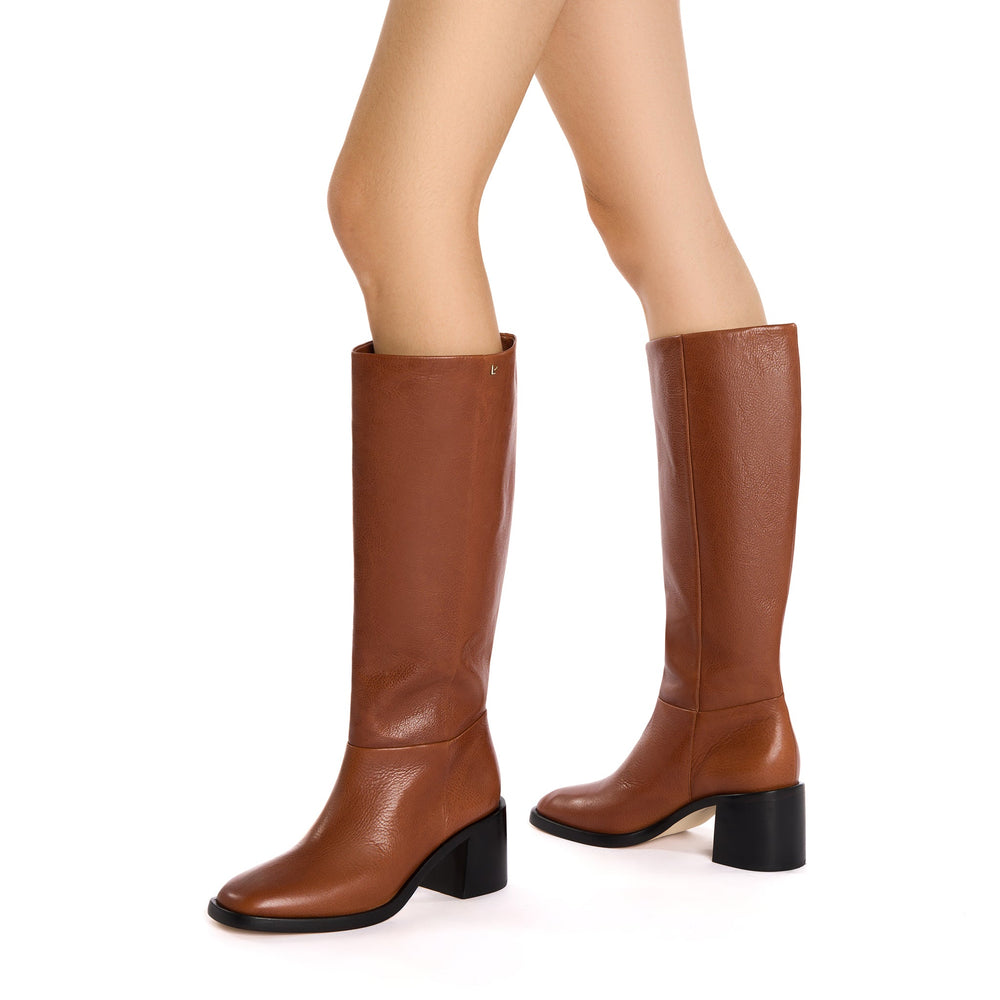 Side view of Ricky knee-high boot in mocca leather showcasing round toe, block heel, and pebble leather texture on white background