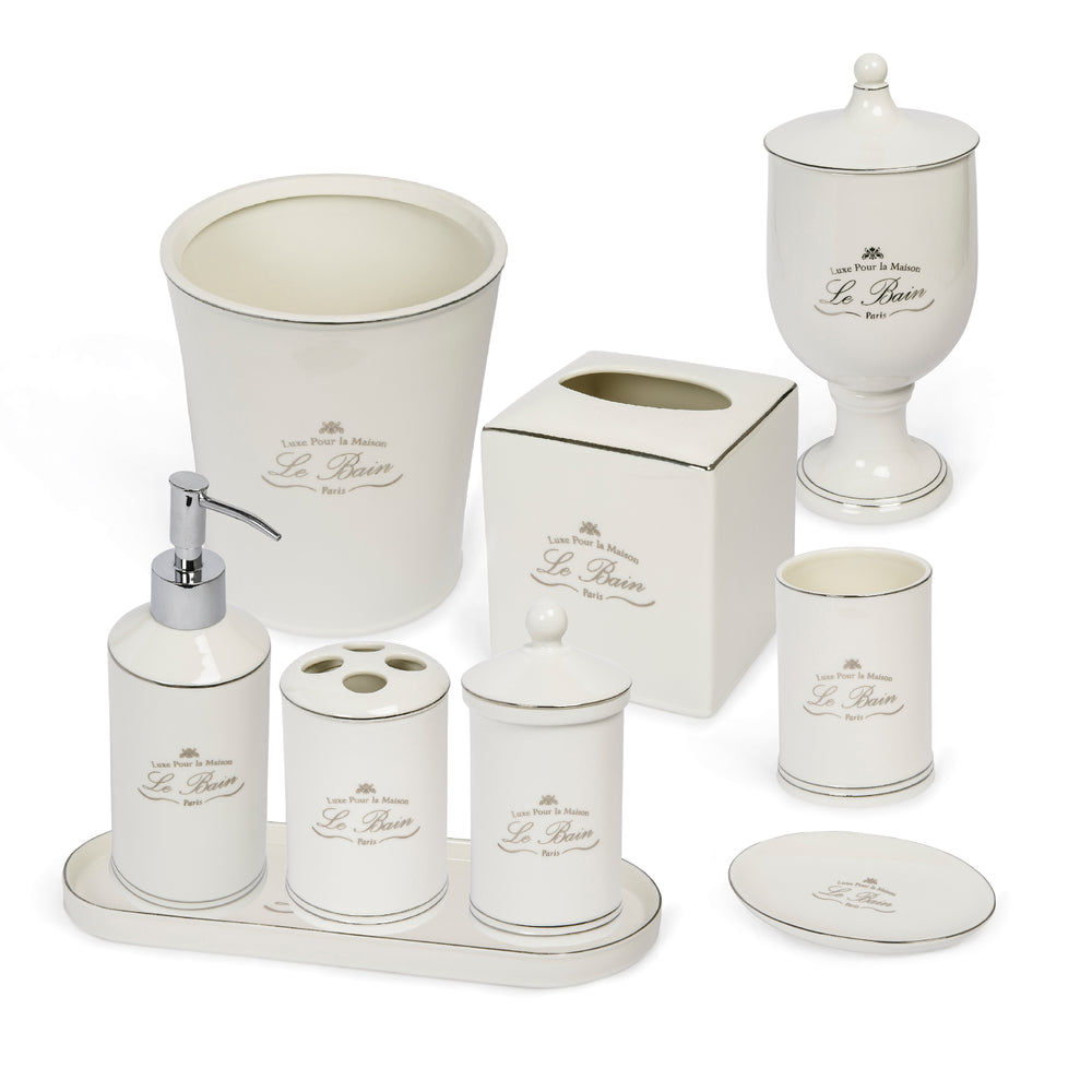 Front view of Le Bain bathroom accessory set showcasing white porcelain pieces with platinum toned trim on white background
