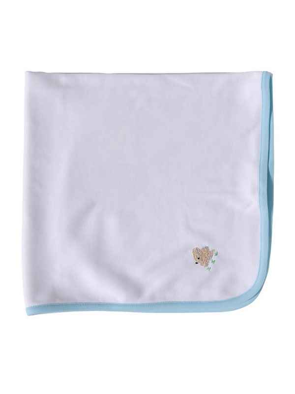 Folded white baby blanket with light blue trim showcasing small cream bunny embroidery on white background