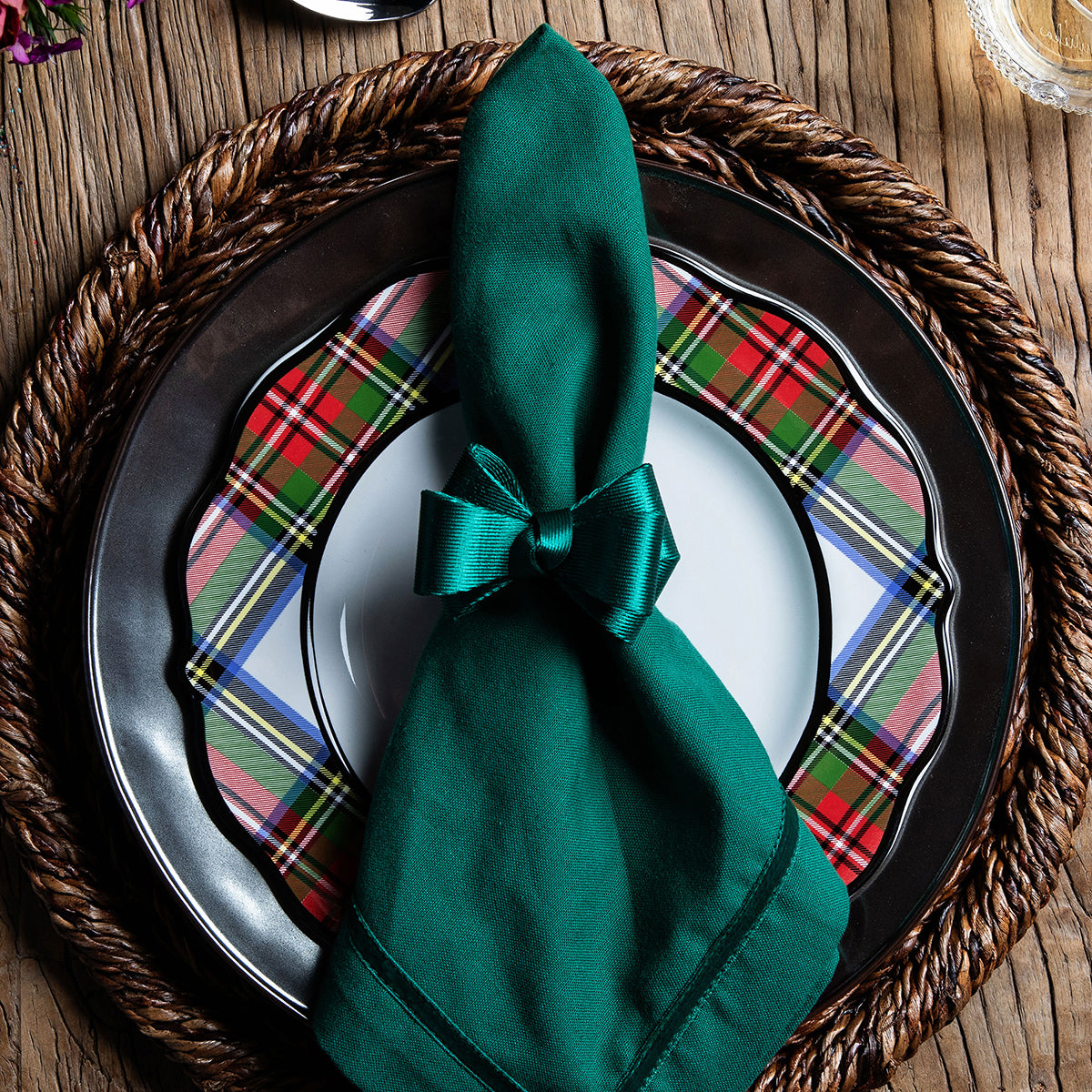 Top view of Tuxedo Evergreen Napkin Ring with green velvet ribbon bow on folded napkin