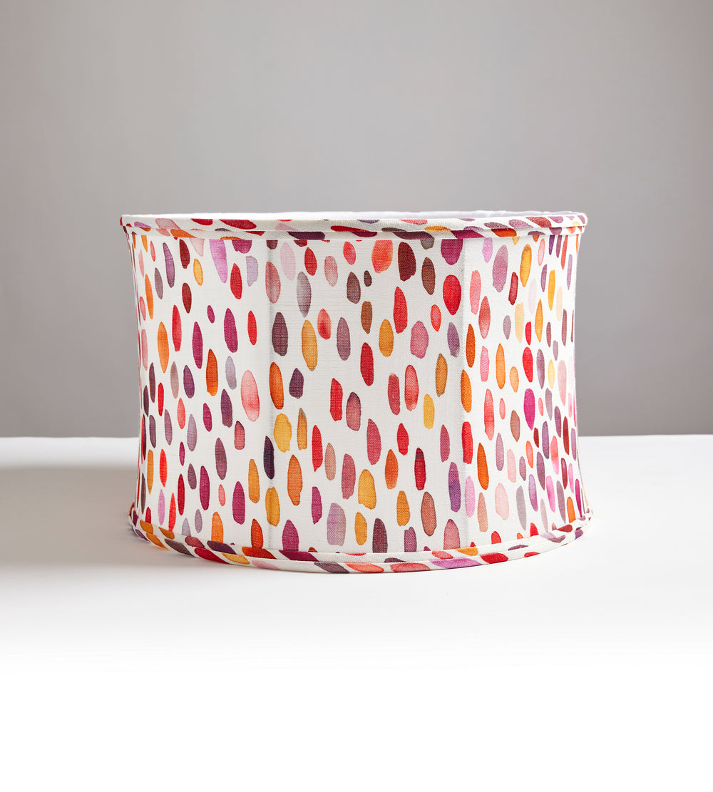 Front view of Jamboree drum lampshade showing multicolored painterly dot pattern in pinks, reds, and orange on white