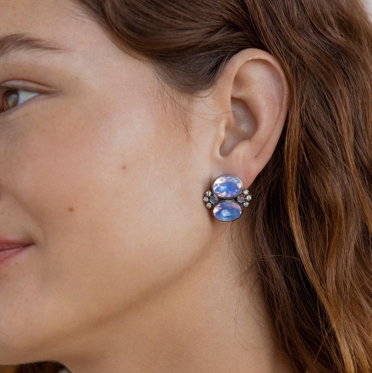 Side view of Luzia Dama Cluster Earrings showcasing oval lavender moon quartz and gemstone clusters on a model