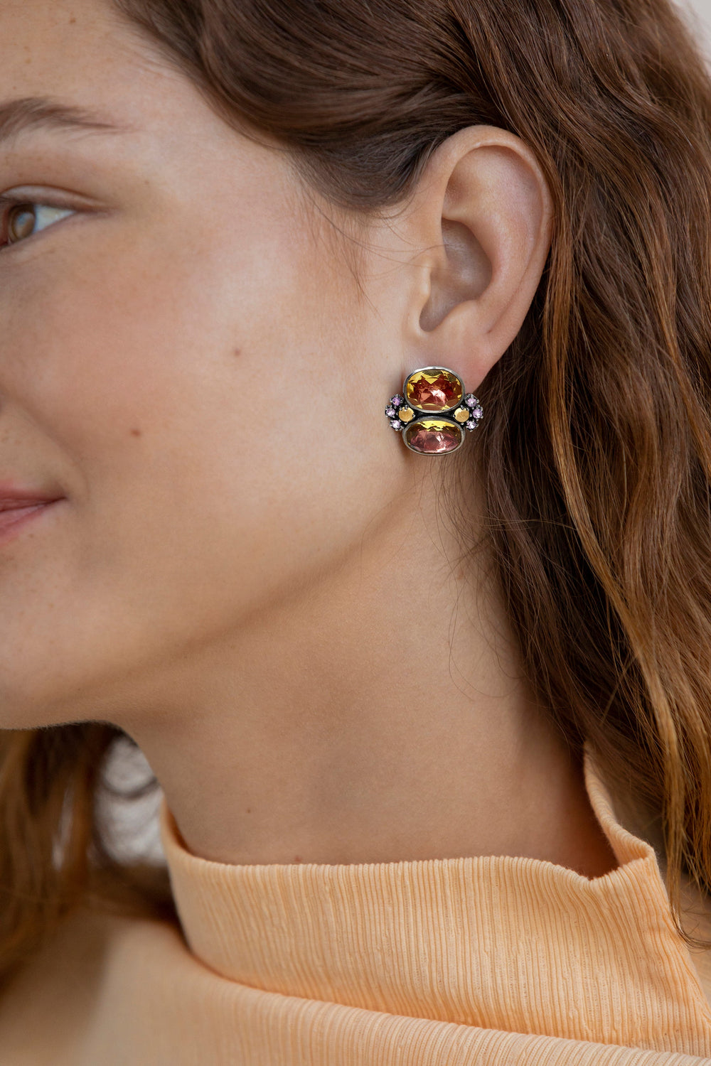Close-up of Luzia Dama Cluster Earrings in yellow citrine showing stacked oval citrines and pink sapphire accents on a model’s ear