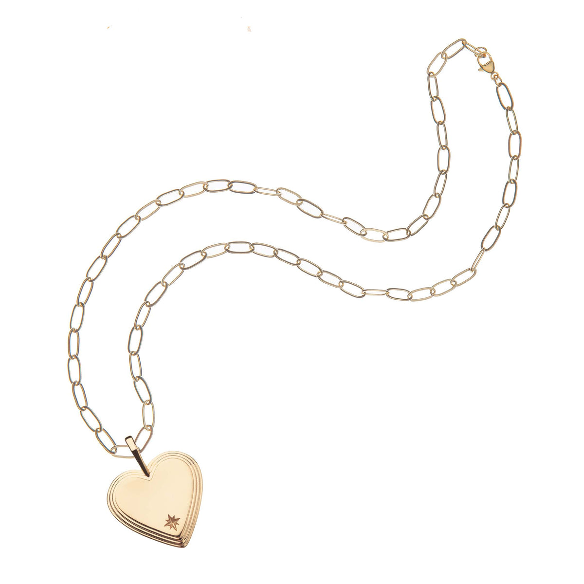 Top view of Layers Of Love heart necklace showing layered heart pendant with starburst engraving on gold paperclip chain