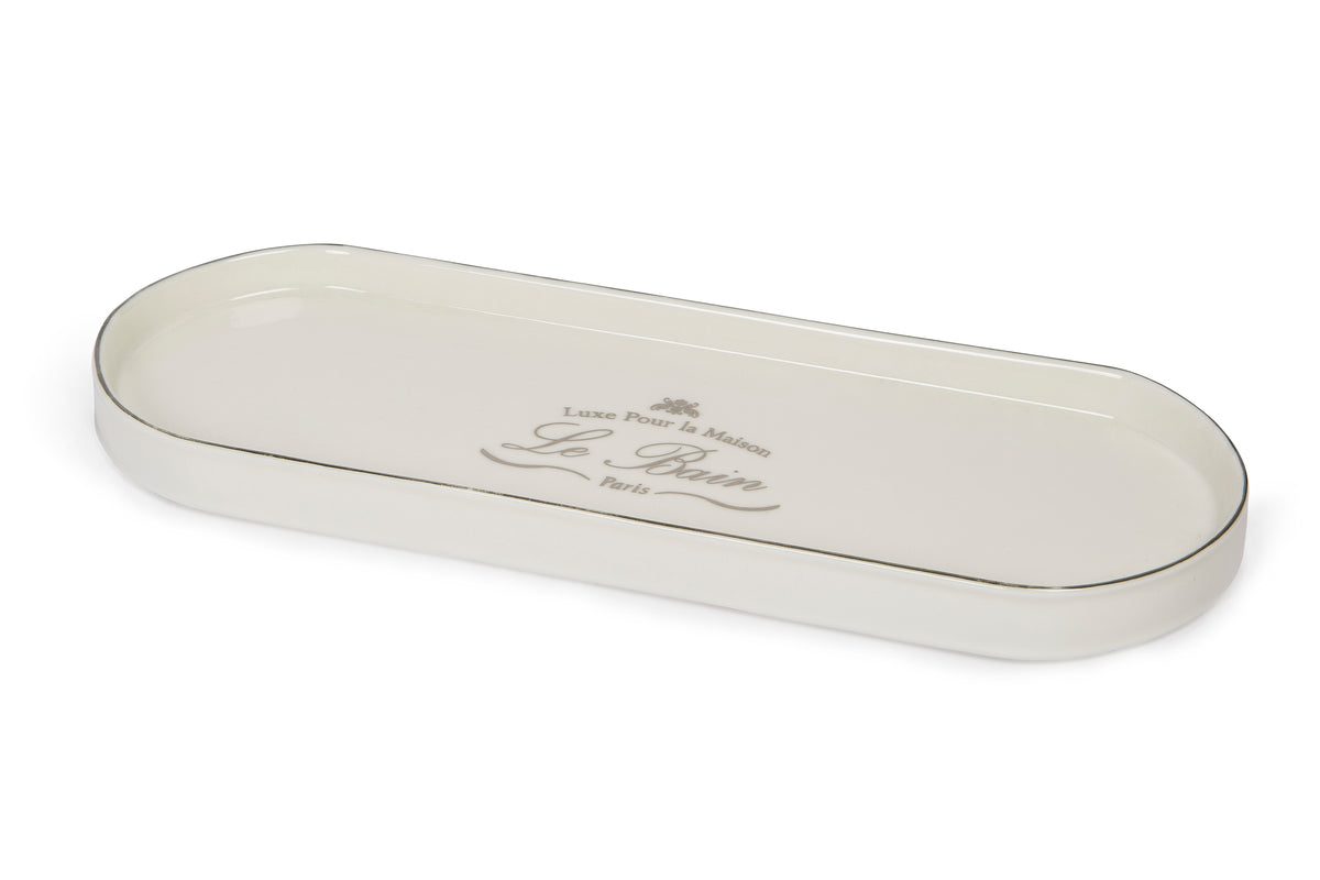 Angled top view of Le Bain porcelain tray showcasing platinum-toned rim and printed Le Bain script on white