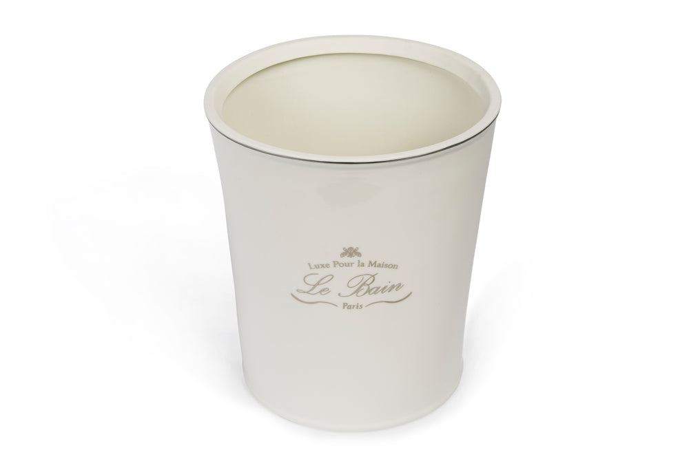 Three-quarter top view of Le Bain waste basket showing white porcelain body and silver-toned rim on a white background
