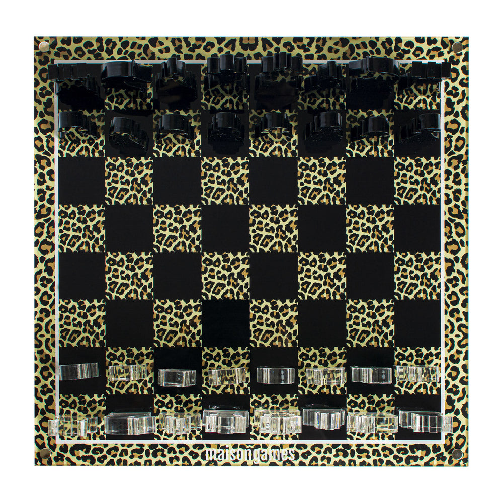 Top-down view of Leopard Chess Set showcasing alternating black and leopard-print squares with clear and black acrylic chess pieces on white background