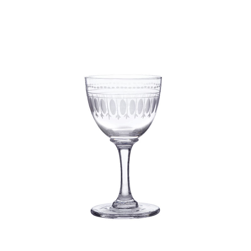 Front view of crystal liqueur glass showcasing hand-engraved oval design on bowl with white background