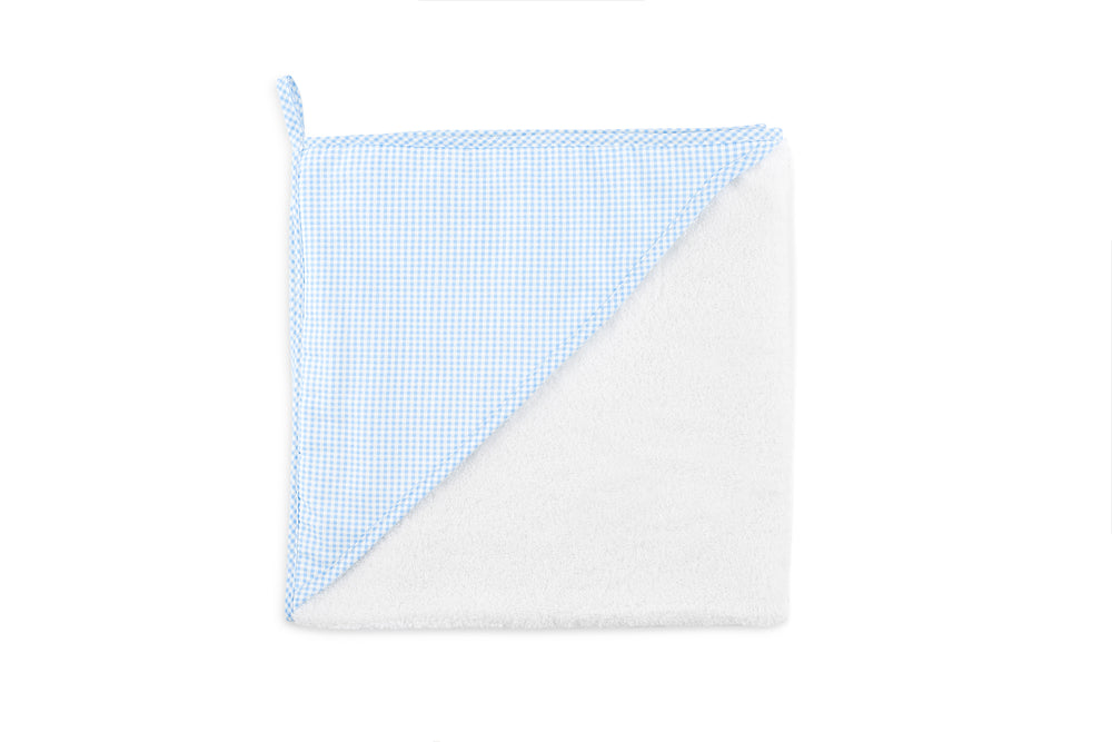Top-down view of Lucky Hooded Towel folded to show blue gingham hood trim and white terry cloth on white background