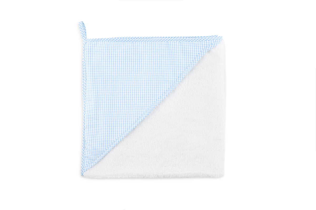 Top-down view of Lucky Hooded Towel folded to show blue gingham hood trim and white terry cloth on white background