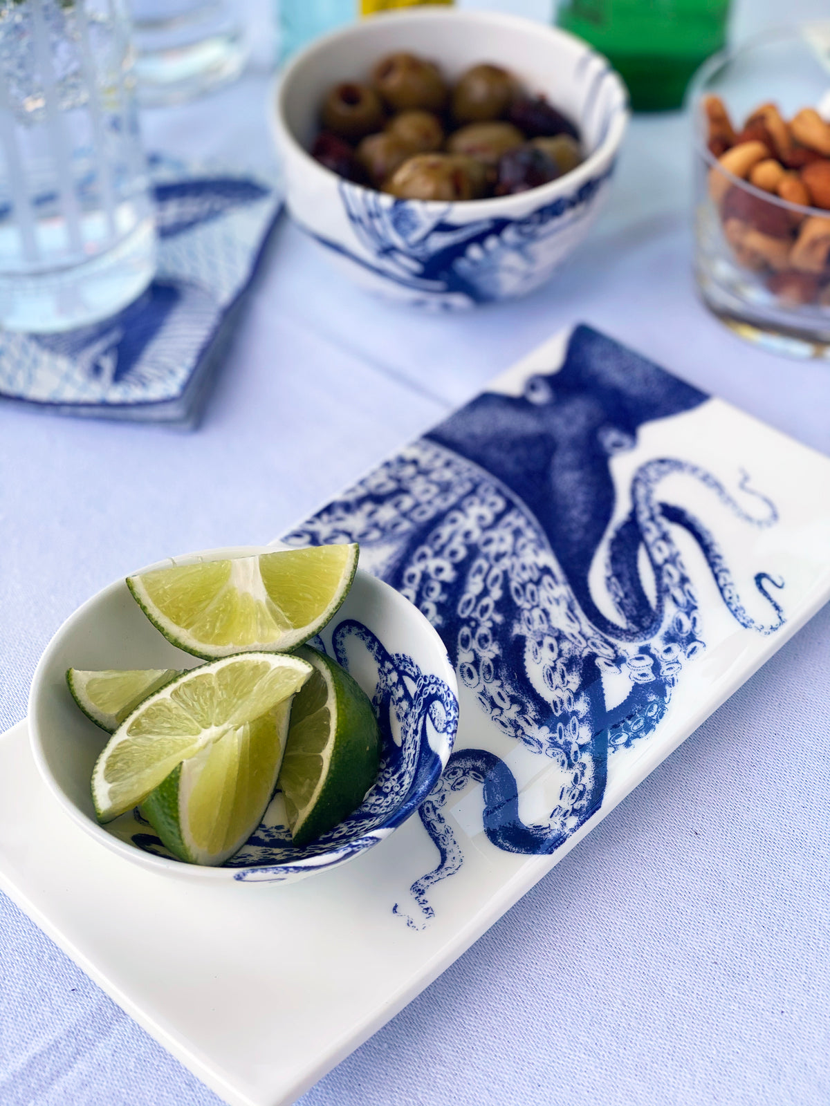 Overhead view of Blue Lucy Snack Bowl showcasing its blue pattern with lime wedges on a serving tray