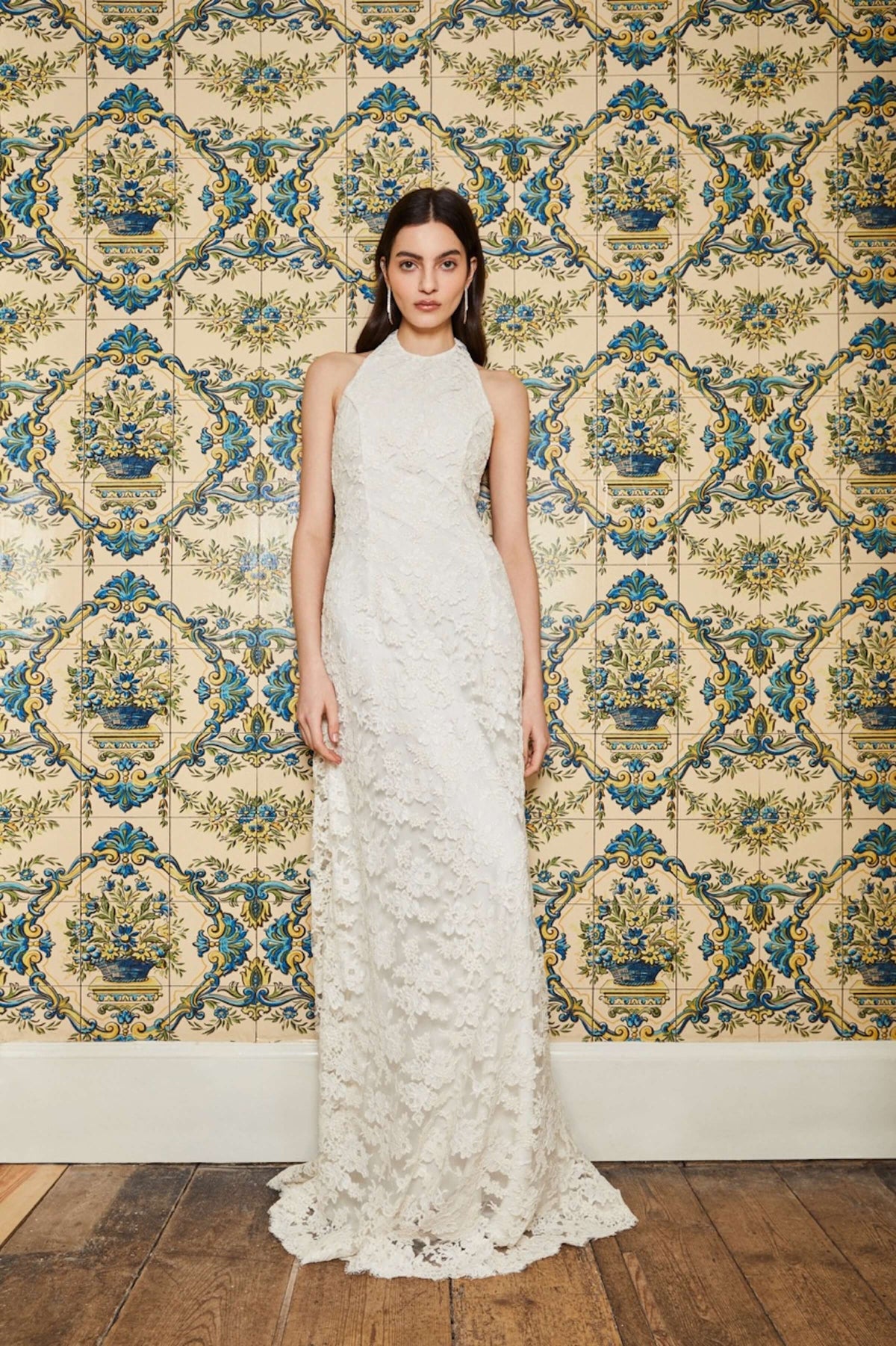 Front view of Sophia White Lace Halter Gown showcasing its high neck and lace detail with patterned tile background