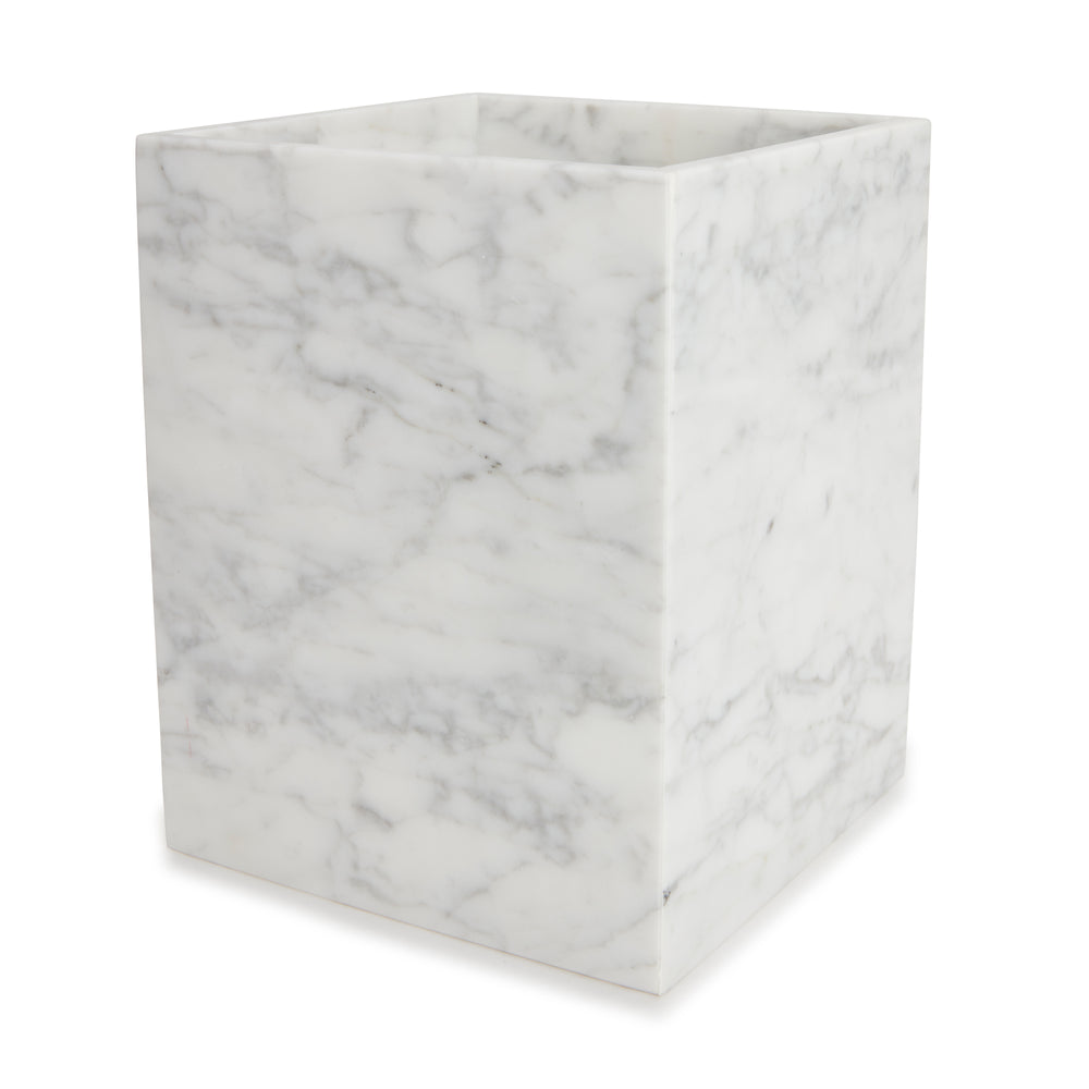 Three-quarter view of Marmol Bath Waste Basket showcasing white Italian marble with gray veining on a white background