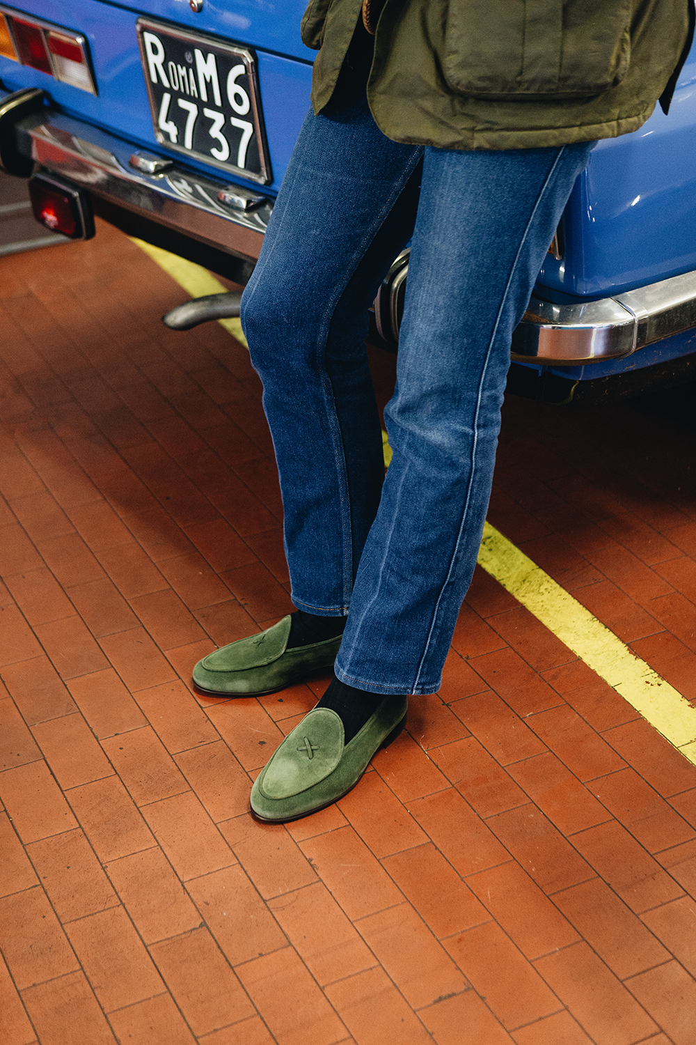 Three-quarter view of Men’s Birch Suede Milano Loafer showcasing birch suede uppers on a model’s feet with a tiled floor background