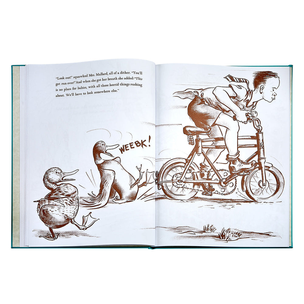 Open spread of Make Way For Ducklings bonded leather journal with sepia illustration of child on a bicycle and ducks