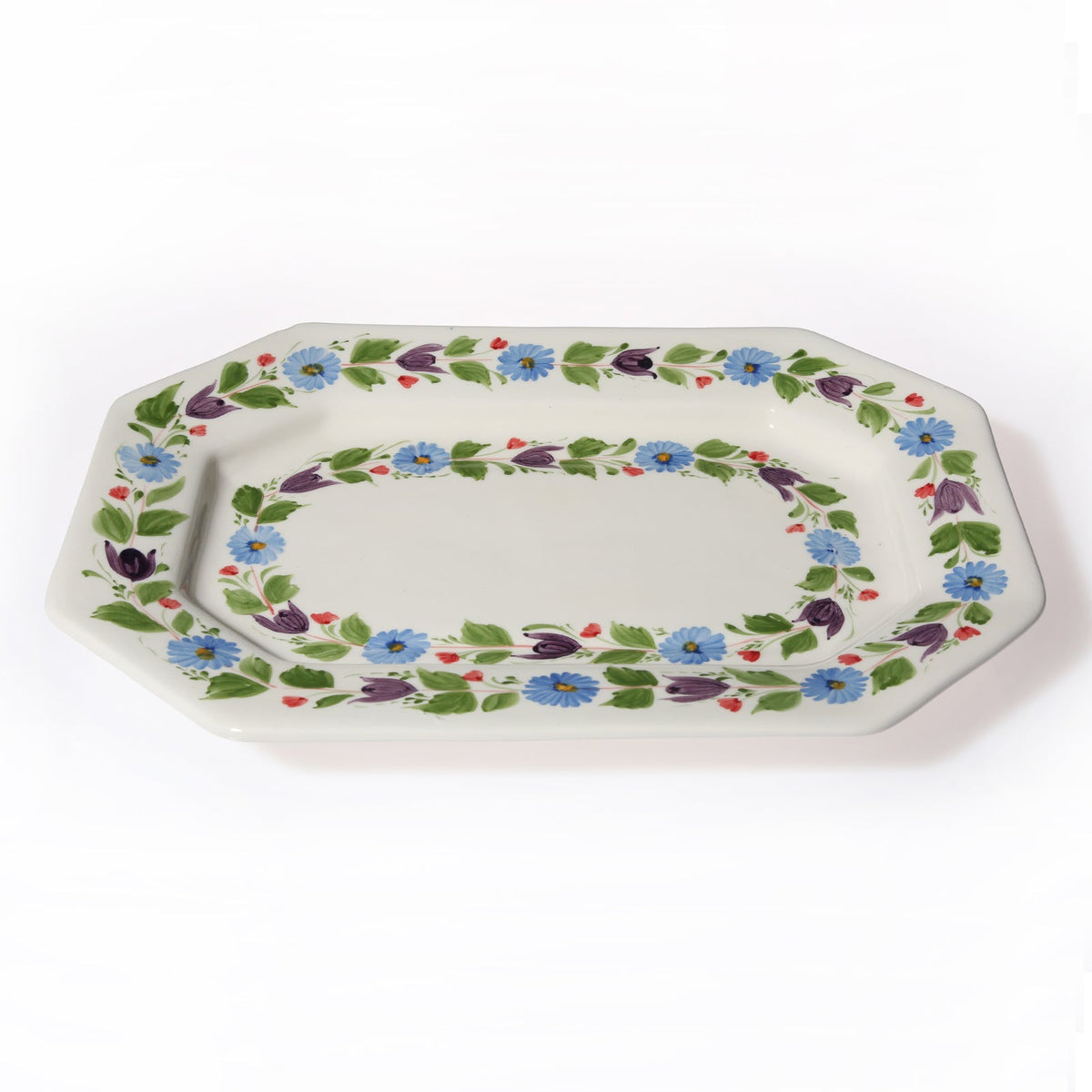 Three-quarter view of Maria Luisa Octagonal Platter showcasing hand-painted swirling floral pattern with a white background