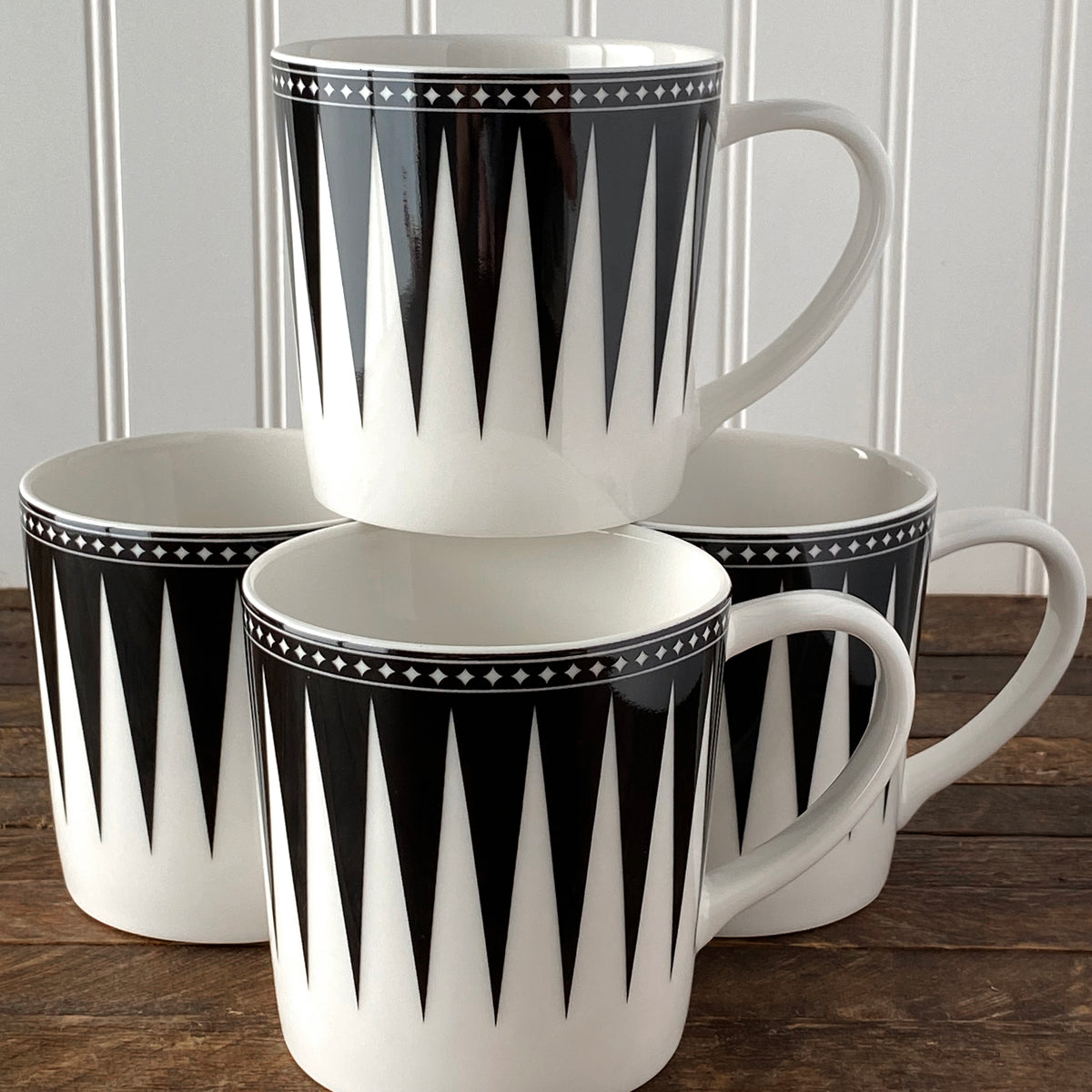 Front view of Marrakech Mug in Black showcasing a black and white geometric pattern with a wood tabletop