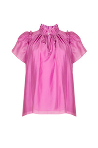 The Millie top has a v-neck with a ruffled collar, a keyhole opening and an optional tie closure.