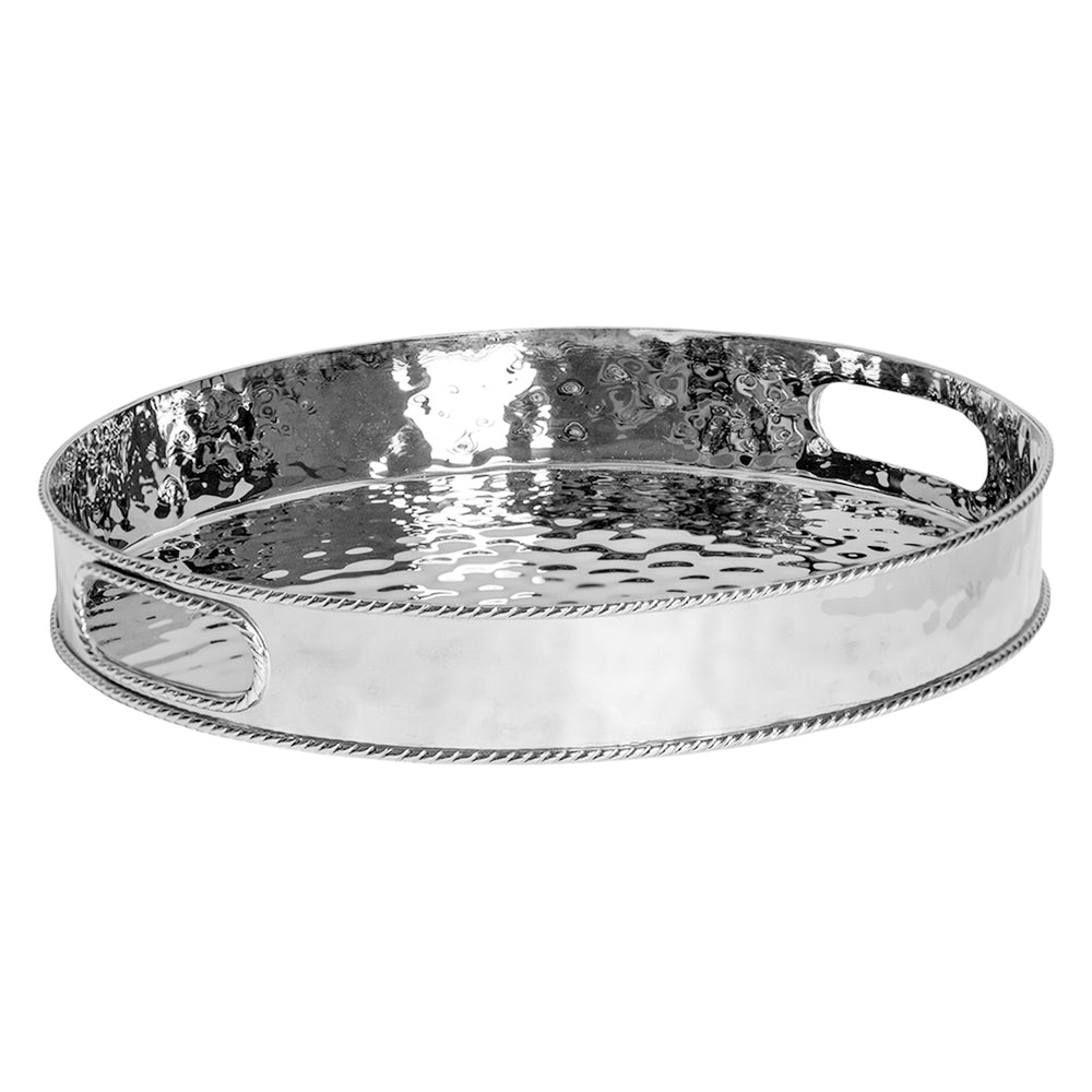 Three-quarter view of Graham Silver Round Tray showcasing hammered stainless steel, raised sides, and handles with a white background