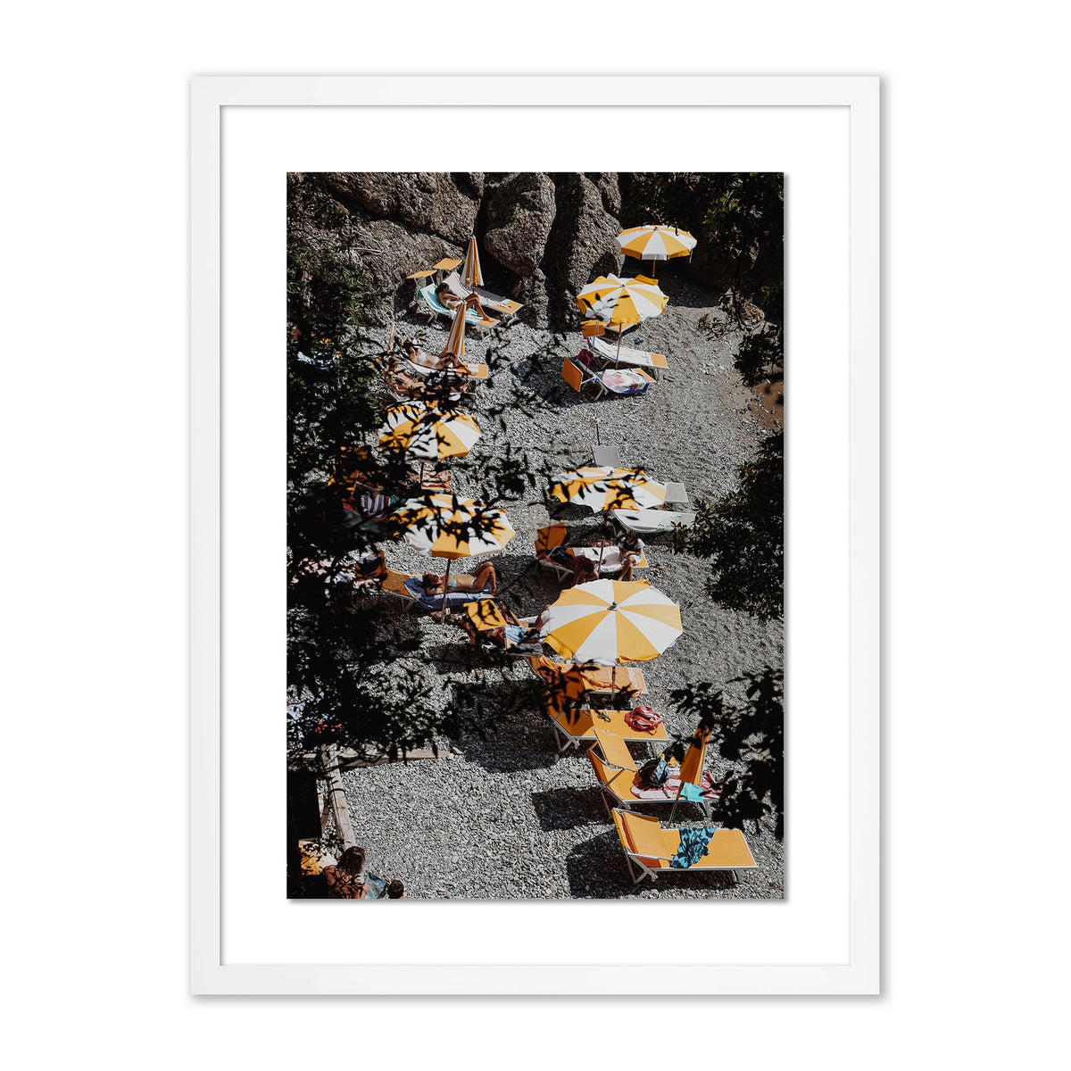 Framed La Cantina print showing aerial view of yellow and white umbrellas and lounge chairs on a pebble beach