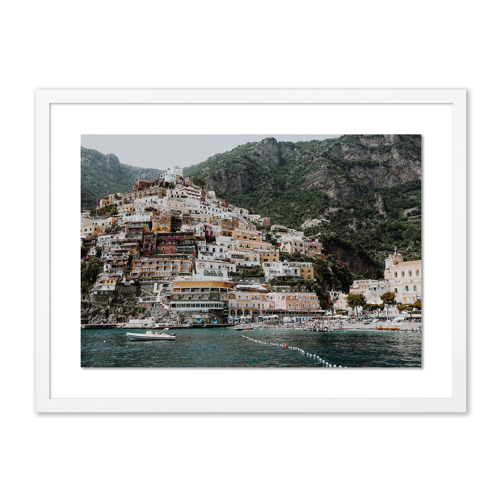 Front view of The Money Shot print framed with white mat showing colorful cliffside town above turquoise sea