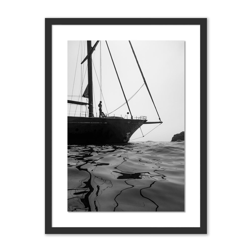 Front view of Li Galli Island framed print showcasing sailboat bow and rippled sea reflections in black and white